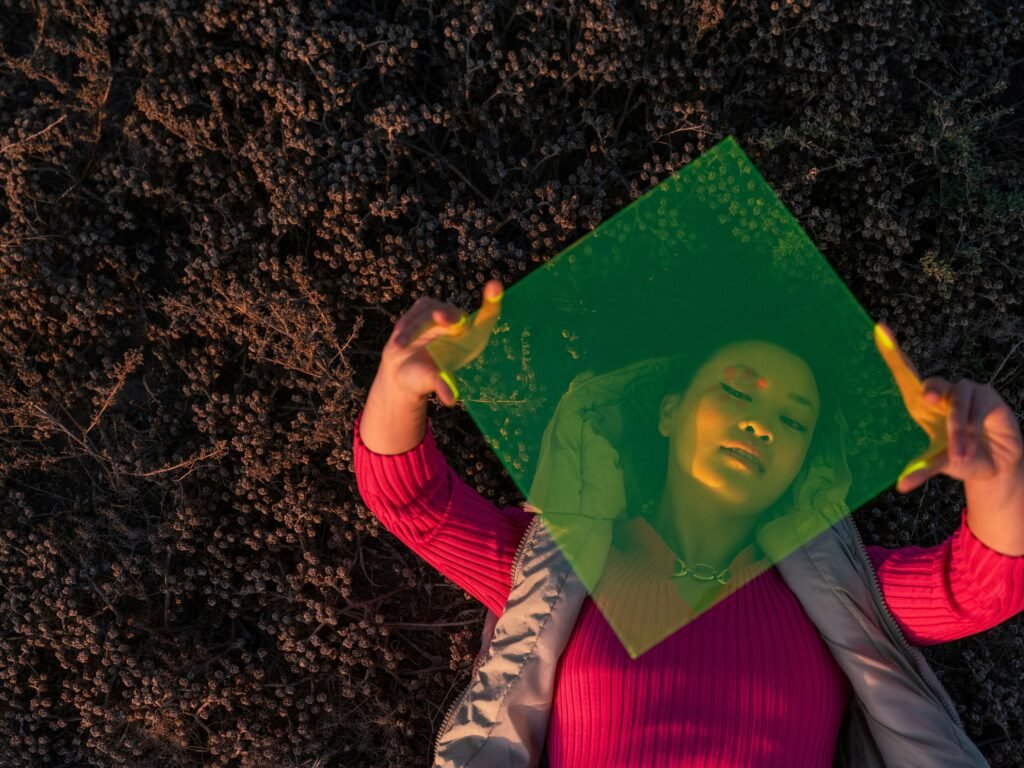 Woman looking through Perspex sheet showing how reality differs to expectations