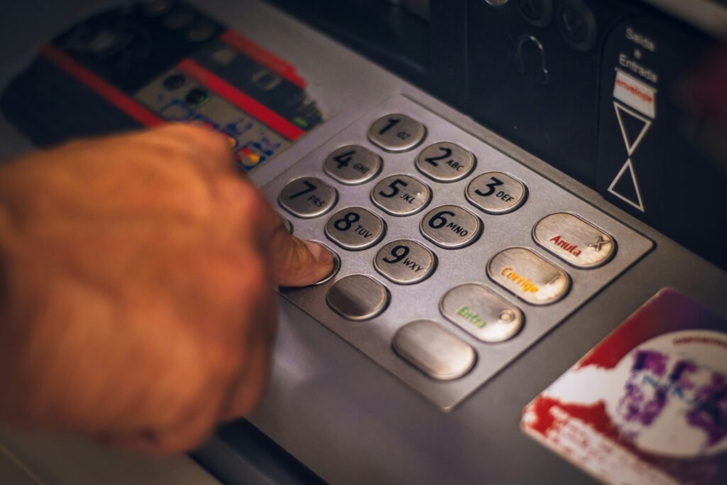 Man typing on an ATM