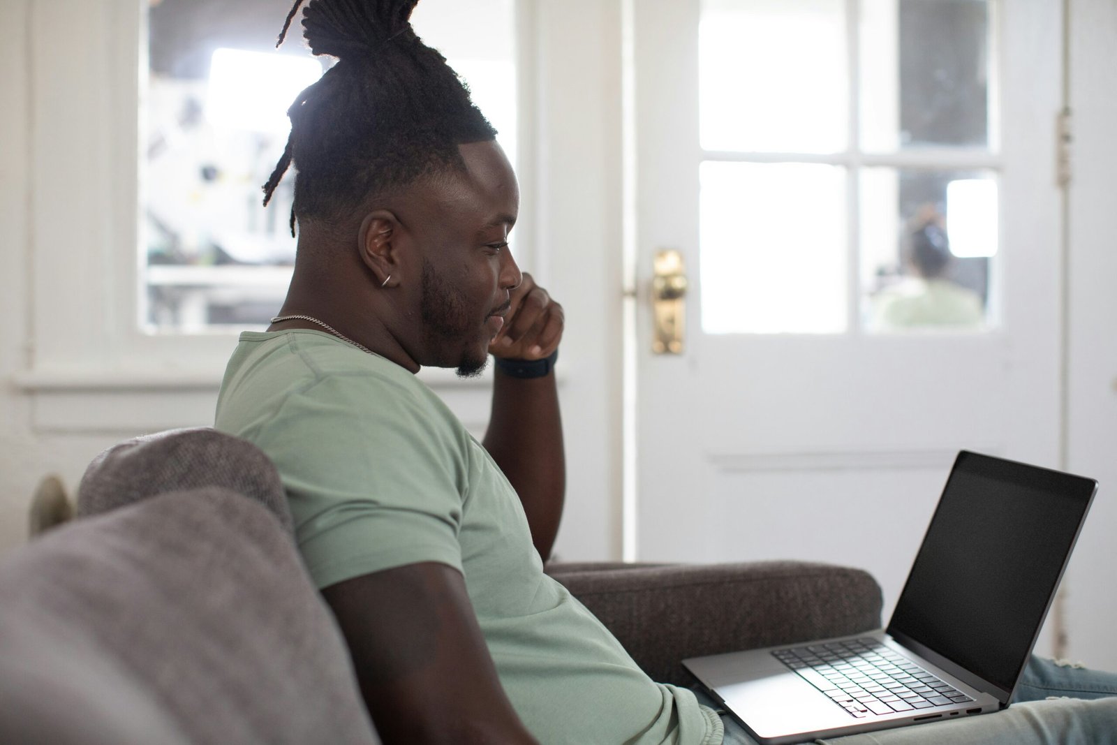 Man in UK thinking on Sofa